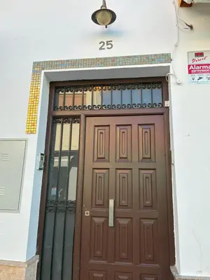 a door to a building with the number on it at Alojamientos Dunas del Alba in Chipiona