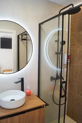 a bathroom with a sink and a mirror at Alojamientos Dunas del Alba in Chipiona