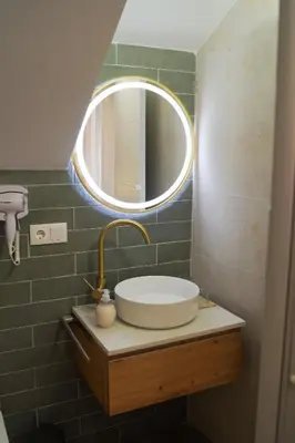 a bathroom with a sink and a mirror at Alojamientos Dunas del Alba in Chipiona