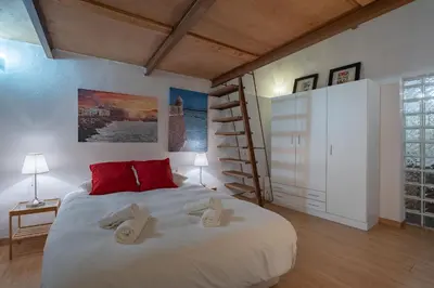 a bedroom with a large bed with slippers on it at CDZ - Santiago Terry in Cádiz