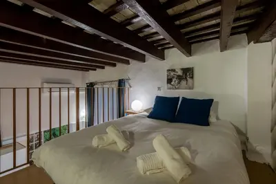 a bedroom with a large white bed with blue pillows at CDZ - Santiago Terry in Cádiz