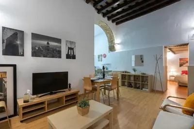 a living room with a television and a dining room at CDZ - Santiago Terry in Cádiz