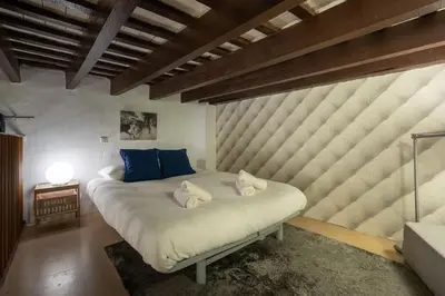 a bedroom with a large white bed with blue pillows at CDZ - Santiago Terry in Cádiz