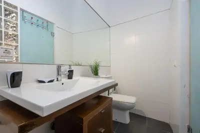 a white bathroom with a sink and a toilet at CDZ - Santiago Terry in Cádiz