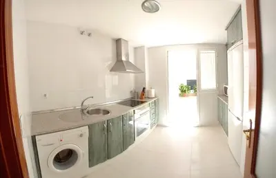 a kitchen with a sink and a washing machine at Castle in Sanlúcar de Barrameda