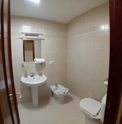 a bathroom with a toilet and a sink at Castle in Sanlúcar de Barrameda
