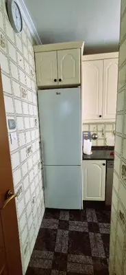 a kitchen with a blue refrigerator and white cabinets at Torre 49 in Cádiz