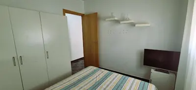 a small room with a bed and a television at Torre 49 in Cádiz