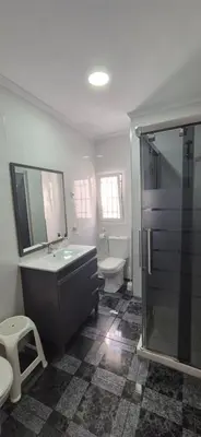 a bathroom with a shower and a sink and a toilet at Torre 49 in Cádiz