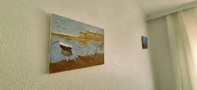a painting of a boat hanging on a wall at Torre 49 in Cádiz