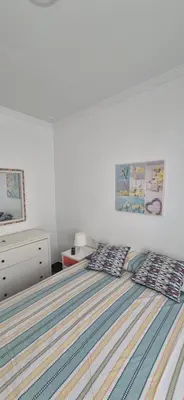 a bedroom with a bed with two pillows on it at Torre 49 in Cádiz