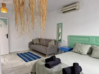 a living room with a bed and a couch at Casa Las Cumbres I - Ole Solutions in El Puerto de Santa María