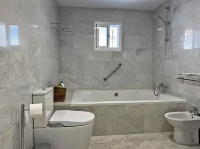 a bathroom with a tub and a toilet and a sink at Casa Las Cumbres I - Ole Solutions in El Puerto de Santa María