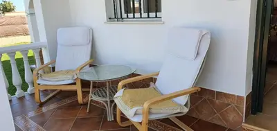 a kitchen with a white refrigerator and a stove at Casa con jardin privado en primera linea de playa in Chipiona