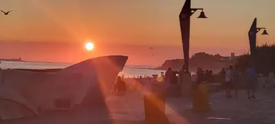 a sunset on a beach with a skateboard ramp at Costa El Castillo La Barrosa in Poblado de Sancti Petri