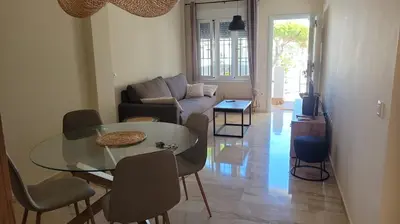 a living room with a glass table and a couch at Costa El Castillo La Barrosa in Poblado de Sancti Petri