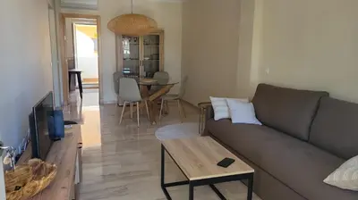 a living room with a couch and a table at Costa El Castillo La Barrosa in Poblado de Sancti Petri