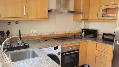 a kitchen with a sink and a dishwasher at Costa El Castillo La Barrosa in Poblado de Sancti Petri
