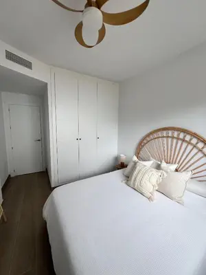 a bedroom with a large white bed with a ceiling at Housfy Beach Costa Ballena by Sanlúcar Housing in Chipiona