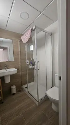 a bathroom with a shower and a toilet and a sink at Housfy Beach Costa Ballena by Sanlúcar Housing in Chipiona