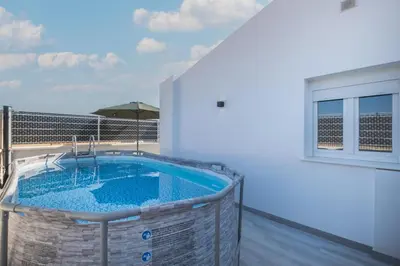 a hot tub on the balcony of a house at Villa Kaki in Conil de la Frontera