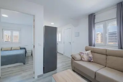 a living room with a couch and a bedroom at Villa Kaki in Conil de la Frontera