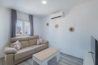 a living room with a couch and a table at Villa Kaki in Conil de la Frontera