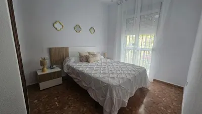 a white bedroom with a bed and a window at Camaron Beach House By Sanlúcar Housing in Chipiona