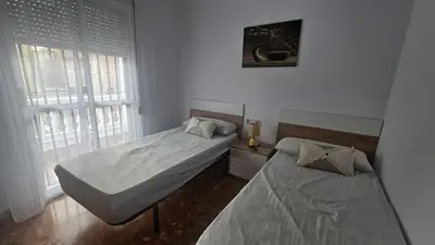 a bedroom with two beds and a window at Camaron Beach House By Sanlúcar Housing in Chipiona