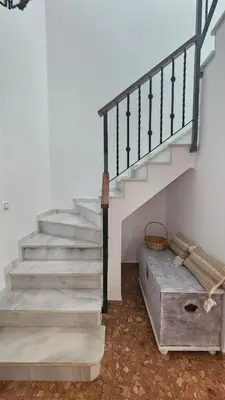 a staircase in a house with a bed next to it at Camaron Beach House By Sanlúcar Housing in Chipiona