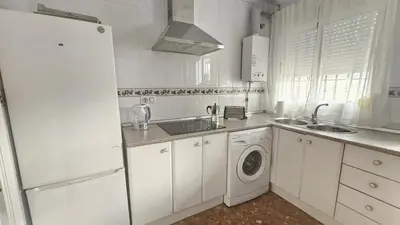 a kitchen with a refrigerator and a washing machine at Camaron Beach House By Sanlúcar Housing in Chipiona
