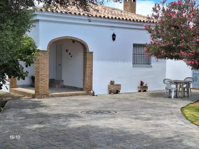 a patio in front of a white house at Chalet casa la adelfa in Chiclana de la Frontera