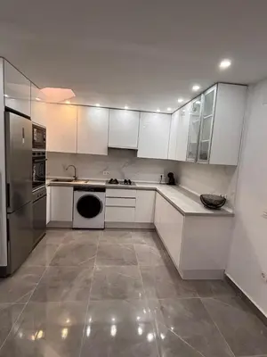 a white kitchen with white cabinets and a dishwasher at Bungalow Bahia Sur 33 in San Fernando