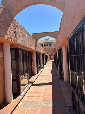 an empty hallway of an old building with an archway at Bungalow Bahia Sur 33 in San Fernando