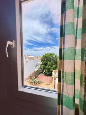 a window with a view of a city at Sibs Sanlucar - casita playa - coqueto vistas in Sanlúcar de Barrameda