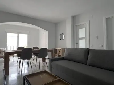 a living room with a couch and a table at Apartoyou Nuevo Puerto Sherry in El Puerto de Santa María
