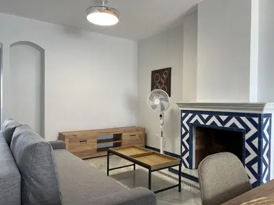 a living room with a couch and a fireplace at Apartoyou Nuevo Puerto Sherry in El Puerto de Santa María