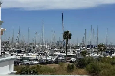 a marina with a bunch of boats in a harbor at Apartoyou Nuevo Puerto Sherry in El Puerto de Santa María