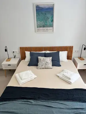 a large bed with two pillows on top of it at Casa Keito, Playa y Patio in Cádiz