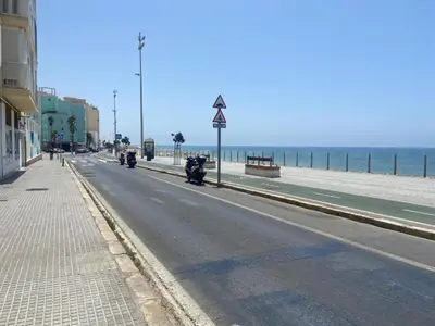 a street with motorcycles parked on the side of a beach at Casa Keito, Playa y Patio in Cádiz