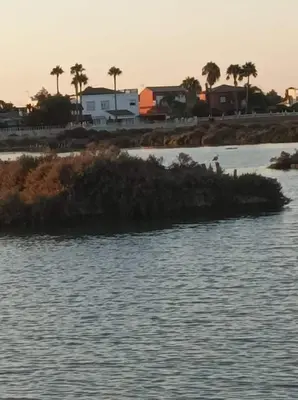 a small island in the water near a beach at Chiclana Apartamento zona playa in Chiclana de la Frontera