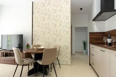 a dining room with a wooden table and chairs at Chiclana Apartamento zona playa in Chiclana de la Frontera