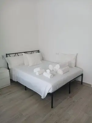 a bed with towels and two teddy bears on it at Mi Rinconcito in Chipiona