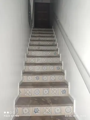 a set of stairs with blue and white tiles at Mi Rinconcito in Chipiona