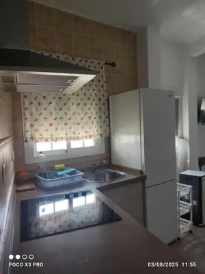 a kitchen with a sink and a refrigerator at Mi Rinconcito in Chipiona