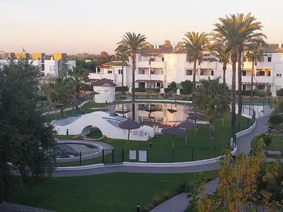 an aerial view of a park with palm trees and buildings at Apartamento Taymar Daniel in Chiclana de la Frontera