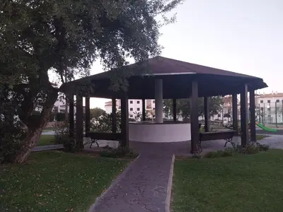 a gazebo with benches in a park at Apartamento Taymar Daniel in Chiclana de la Frontera