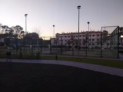 an empty park with a building in the background at Apartamento Taymar Daniel in Chiclana de la Frontera