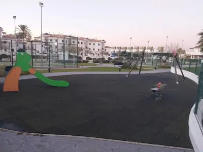 an empty playground with swings and a playground at Apartamento Taymar Daniel in Chiclana de la Frontera