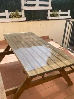 a wooden picnic table sitting on top of a patio at Apartamento Colegueo in Sanlúcar de Barrameda